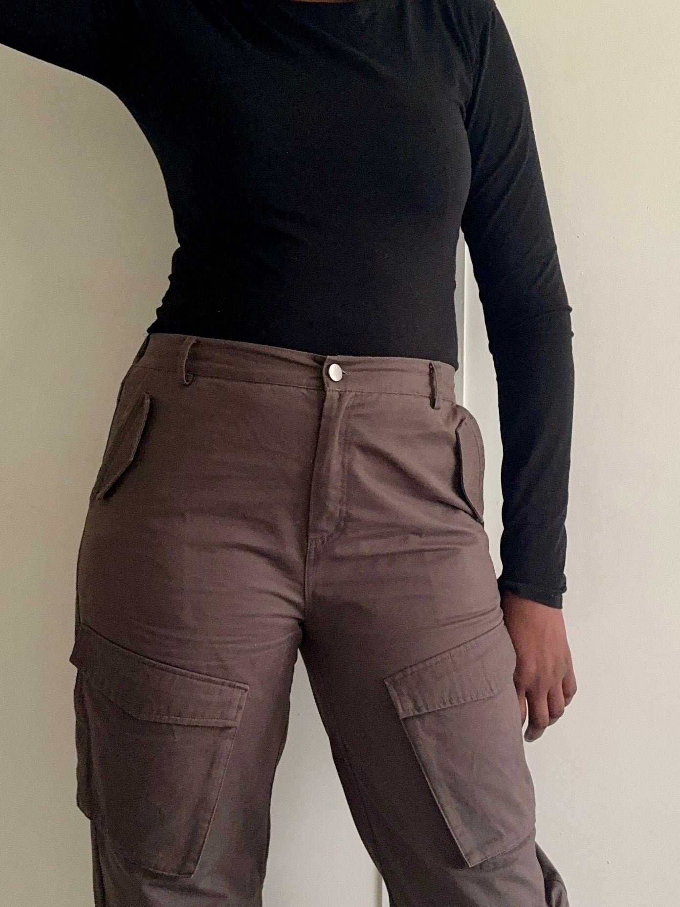 Close-up of pocket and fabric detail on khaki cargo trousers
