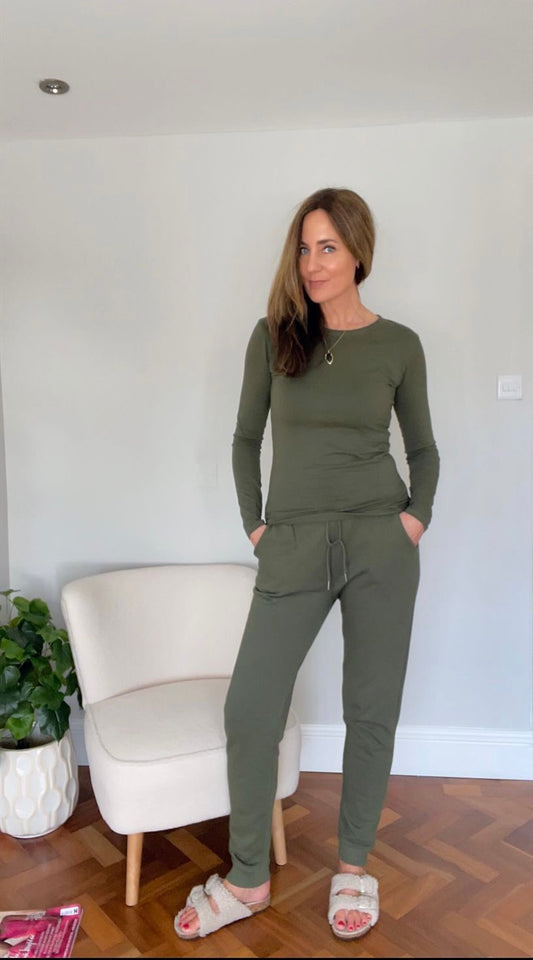 Tall women’s khaki joggers styled with neutral sandals and long sleeve top